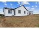 View of the backyard of a white house with black trim windows at 14390 Heritage Dr, Mead, CO 80504