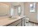 A well-lit bathroom featuring double sinks, modern fixtures, and sleek countertop at 14390 Heritage Dr, Mead, CO 80504