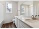 Modern bathroom with a sleek white vanity, tub, and a large mirror, perfect for a refreshing start at 14390 Heritage Dr, Mead, CO 80504