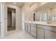 Elegant bathroom with double vanity, quartz countertops, and marble tile flooring at 14390 Heritage Dr, Mead, CO 80504