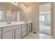 Stylish bathroom with double vanity, modern fixtures, and natural light from window at 14390 Heritage Dr, Mead, CO 80504