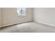 A bedroom with neutral walls, plush carpeting, and a window providing natural light at 14390 Heritage Dr, Mead, CO 80504