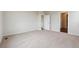 Carpeted bedroom space with ample room, featuring neutral walls and access to multiple hallways at 14390 Heritage Dr, Mead, CO 80504