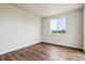 Bright bedroom features hardwood floors and a large window offering neighborhood views at 14390 Heritage Dr, Mead, CO 80504