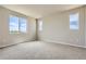 Bright bedroom featuring three windows and neutral carpeting at 14390 Heritage Dr, Mead, CO 80504