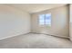 Spacious bedroom with large window offers natural light and neutral carpet at 14390 Heritage Dr, Mead, CO 80504