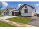 Beautiful single Gathering home featuring a 2 car garage and a small tree in the front lawn at 14390 Heritage Dr, Mead, CO 80504