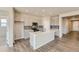 Modern kitchen featuring stainless steel appliances, gray subway tile backsplash, and a large center island at 14390 Heritage Dr, Mead, CO 80504