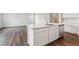 Modern kitchen island features white cabinetry, stainless steel appliances and quartz countertops at 14390 Heritage Dr, Mead, CO 80504