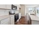 Modern kitchen featuring white cabinets, quartz countertops, and stainless steel appliances, offering style at 14390 Heritage Dr, Mead, CO 80504