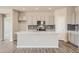 Bright kitchen boasts gray cabinets, subway tile backsplash, and large central island at 14390 Heritage Dr, Mead, CO 80504