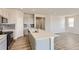 Open kitchen concept with island, stainless steel appliances, and gray subway tile backsplash at 14390 Heritage Dr, Mead, CO 80504
