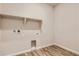 This laundry room offers plenty of space and natural light with wood look flooring at 14390 Heritage Dr, Mead, CO 80504