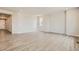 Large open concept room with light walls and wood flooring offers flexible layout options at 14390 Heritage Dr, Mead, CO 80504