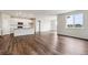 Open floor plan with hardwood floors leads to a bright kitchen and ample window views at 14390 Heritage Dr, Mead, CO 80504