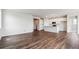 Spacious living room featuring hardwood floors with an open floor plan to the kitchen at 14390 Heritage Dr, Mead, CO 80504