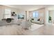 Bright living room with contemporary furniture, light wood floors, and large windows offering great views at 14390 Heritage Dr, Mead, CO 80504