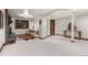 Spacious basement area with a stone fireplace, and seating area with natural light at 1290 S Lininger Dr, Golden, CO 80401