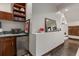 Basement bar area with small refrigerator, built-in shelves and display area on the wall at 1290 S Lininger Dr, Golden, CO 80401