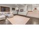 Basement entertainment area with comfortable seating, exposed flooring and carpeted stairs at 1290 S Lininger Dr, Golden, CO 80401