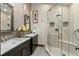 Modern bathroom featuring double sinks, sleek fixtures, and a glass-enclosed shower at 1290 S Lininger Dr, Golden, CO 80401