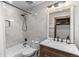 Bright bathroom features marble tile, soaking tub, sleek fixtures, and a vanity with ample storage at 1290 S Lininger Dr, Golden, CO 80401