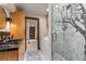 An uniquely designed bathroom featuring mosaic tile, custom lighting, and a glass-enclosed shower at 1290 S Lininger Dr, Golden, CO 80401