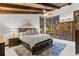 Spacious bedroom featuring wood-beamed ceilings and large windows with scenic views at 1290 S Lininger Dr, Golden, CO 80401