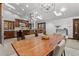 Open-concept dining room with wood table and a modern chandelier, bathed in natural light at 1290 S Lininger Dr, Golden, CO 80401