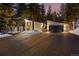 Front exterior of a modern home featuring a garage and driveway surrounded by mature trees at 1290 S Lininger Dr, Golden, CO 80401