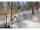 Inviting hot tub offering picturesque mountain views, surrounded by tall trees in a snow-covered forest at 1290 S Lininger Dr, Golden, CO 80401