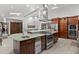 Spacious kitchen with stainless steel appliances, island, and light tile floors at 1290 S Lininger Dr, Golden, CO 80401