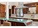 Close-up of kitchen with stainless steel appliances, glass countertop, and wood cabinets at 1290 S Lininger Dr, Golden, CO 80401