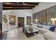 Bright living room featuring exposed wood beams, large windows, and a comfortable white sofa at 1290 S Lininger Dr, Golden, CO 80401