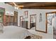 Bedroom with access to bath, featuring wood beam ceiling, carpet, and a walk out at 1290 S Lininger Dr, Golden, CO 80401