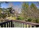 Enjoy lush backyard scenery from this balcony showcasing mature trees and sprawling green space for outdoor enjoyment at 6251 Willow Ln, Boulder, CO 80301