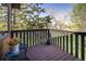 Cozy balcony with wood flooring offers outdoor living space with views of mature trees and landscaping at 6251 Willow Ln, Boulder, CO 80301