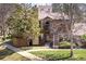 Charming townhome with a cozy front entrance, a lush lawn, and mature trees at 6251 Willow Ln, Boulder, CO 80301
