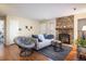Inviting living room with a stone fireplace and comfortable seating area with hardwood floors at 6251 Willow Ln, Boulder, CO 80301