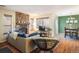 Comfortable living room with hardwood floors, stone fireplace, and a view of the dining area at 6251 Willow Ln, Boulder, CO 80301