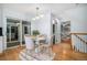 Elegant dining room with a round table and chairs, hardwood floors, and access to the kitchen at 3930 S Hillcrest Dr, Denver, CO 80237