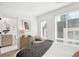 Stylish bedroom with accent wall and a view into a bright, modern bathroom at 5128 W 26Th Ave # 207, Denver, CO 80212
