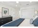 Bright bedroom with blue accents, modern black dresser and ample closet space at 5128 W 26Th Ave # 207, Denver, CO 80212