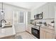Modern kitchen with stainless steel appliances, sleek cabinets, and a stylish backsplash at 5128 W 26Th Ave # 207, Denver, CO 80212