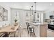 Bright kitchen featuring stainless steel appliances, island with seating, and hardwood floors at 5128 W 26Th Ave # 207, Denver, CO 80212