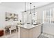 Modern kitchen with an island featuring a stainless steel sink, sleek faucet, and pendant lighting at 5128 W 26Th Ave # 207, Denver, CO 80212