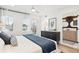 Bright bedroom with a ceiling fan, balcony access, and a view into the ensuite bathroom at 5128 W 26Th Ave # 207, Denver, CO 80212