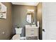 Chic powder room with modern vanity, oval mirror, and stylish neutral decor at 5128 W 26Th Ave # 207, Denver, CO 80212