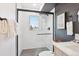 Stylish shower with hexagon floor tiles, herringbone wall tiles, and a view at 5128 W 26Th Ave # 207, Denver, CO 80212
