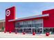 Exterior view of a bright red Target store with its iconic logo, ample parking, and clear glass entrance doors at 5128 W 26Th Ave # 207, Denver, CO 80212